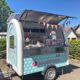 Waffle cart with open sales flap in a car park 